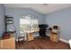 Bright home office with modern desk setup, wood-look floors, and decorative window at 2727 S 160 Ln, Goodyear, AZ 85338