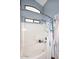 Bathtub with shower with blue accent wall and window at 2727 S 160 Ln, Goodyear, AZ 85338