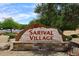 Sarival Village community sign, beautifully crafted with natural stone accents and lush landscaping at 2727 S 160 Ln, Goodyear, AZ 85338