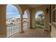 Charming covered balcony with arched entryways and views of the neighborhood at 2854 N Claire Dr, Buckeye, AZ 85396