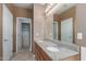 Bathroom with double sinks, granite counters, and a closet with drawers, providing ample storage at 2854 N Claire Dr, Buckeye, AZ 85396