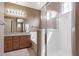 Bright bathroom featuring a walk-in shower, soaking tub, wood cabinets and granite countertops at 2854 N Claire Dr, Buckeye, AZ 85396
