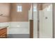 Bright bathroom with natural light and a shower and tub with white tile at 2854 N Claire Dr, Buckeye, AZ 85396