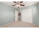 Bedroom with carpet, fan, closet with sliding doors and doorway at 2854 N Claire Dr, Buckeye, AZ 85396