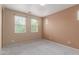 Inviting bedroom with soft carpet, natural light streaming through windows, and a neutral color palette at 2854 N Claire Dr, Buckeye, AZ 85396