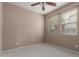 Neutral bedroom with carpet, fan, and natural light from the two windows at 2854 N Claire Dr, Buckeye, AZ 85396