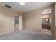 Neutral bedroom showcasing carpet and an open doorway to an ensuite bathroom at 2854 N Claire Dr, Buckeye, AZ 85396