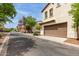 Charming two-story home with a two-car garage nestled in a well-maintained community street with mature trees at 2854 N Claire Dr, Buckeye, AZ 85396
