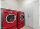 Laundry room featuring red front-loading washer and dryer units at 2854 N Claire Dr, Buckeye, AZ 85396
