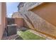 A backyard includes an AC unit, brick trim, small patch of grass, and rock ground cover at 2862 E Megan St, Gilbert, AZ 85295