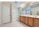 Bright bathroom with a large mirror, a bathtub, tiled floors and double sinks at 2862 E Megan St, Gilbert, AZ 85295