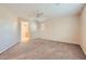 Spacious bedroom with neutral carpet, a ceiling fan, and an ensuite bath at 2862 E Megan St, Gilbert, AZ 85295