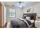Comfortable bedroom with plush gray carpet, ceiling fan, and a decorative upholstered headboard at 2862 E Megan St, Gilbert, AZ 85295