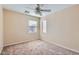 This bedroom has neutral carpet, light walls, and two windows for natural light and features a ceiling fan at 2862 E Megan St, Gilbert, AZ 85295