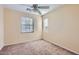 This bedroom has neutral carpet, light walls, and two windows for natural light and features a ceiling fan at 2862 E Megan St, Gilbert, AZ 85295