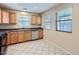 Bright eat-in kitchen features a tile floor, and stainless dishwasher and sink at 2862 E Megan St, Gilbert, AZ 85295