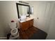 Compact bathroom with a vanity, mirror, wood-look flooring, and toilet at 2981 S 257Th Ave, Buckeye, AZ 85326