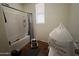 Cozy bathroom with a shower-tub combination, storage shelves, and a window at 2981 S 257Th Ave, Buckeye, AZ 85326