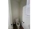 This half bathroom has a toilet, hardwood flooring, and a single window at 2981 S 257Th Ave, Buckeye, AZ 85326