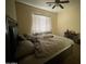 Bedroom featuring a bed, ceiling fan, and window with blinds and curtains at 2981 S 257Th Ave, Buckeye, AZ 85326