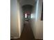 Long hallway leading to a bedroom with a neutral palette, providing a sense of depth and flow at 2981 S 257Th Ave, Buckeye, AZ 85326