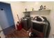 Functional laundry area featuring modern washer and dryer, and plenty of shelving for storage and supplies at 2981 S 257Th Ave, Buckeye, AZ 85326