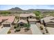 Aerial view of a two-story home with desert landscaping and mountain views at 31221 N 130Th Ln, Peoria, AZ 85383