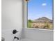 Bright bathroom featuring tub and a picturesque window view of desert landscape at 31221 N 130Th Ln, Peoria, AZ 85383