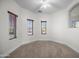 Bedroom with carpet flooring, ceiling fan, and lots of natural light from three windows at 31221 N 130Th Ln, Peoria, AZ 85383