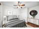 Comfortable bedroom with hardwood floors, ceiling fan, and modern decor at 31221 N 130Th Ln, Peoria, AZ 85383