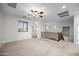 Spacious bonus room with carpet flooring and ample natural light from several windows at 31221 N 130Th Ln, Peoria, AZ 85383