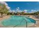 Large community pool with lounge areas and meticulously maintained desert landscaping at 31221 N 130Th Ln, Peoria, AZ 85383