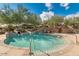 Inviting community pool featuring a waterslide, spa, and desert landscaping at 31221 N 130Th Ln, Peoria, AZ 85383