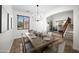 A bright dining room features a chandelier and a view of the front yard, creating an inviting space at 31221 N 130Th Ln, Peoria, AZ 85383