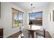 Bright dining room featuring decorative chandelier and large windows with backyard view at 31221 N 130Th Ln, Peoria, AZ 85383