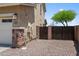 Home exterior features a two-car garage, stone accents, and a fenced gravel area at 31221 N 130Th Ln, Peoria, AZ 85383