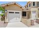 Attached two-car garage with white door, adjacent to the home's front entryway at 31221 N 130Th Ln, Peoria, AZ 85383