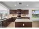 Open kitchen with stainless steel appliances, granite countertops, tile backsplash, and center island at 31221 N 130Th Ln, Peoria, AZ 85383