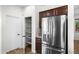 Kitchen featuring stainless steel refrigerator and walk-in pantry for plenty of storage space at 31221 N 130Th Ln, Peoria, AZ 85383