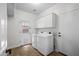 Spacious laundry room with washer, dryer, storage cabinets and convenient access to the backyard at 31221 N 130Th Ln, Peoria, AZ 85383