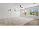 Large living room with plenty of natural light, carpet flooring and a backyard pool view at 31221 N 130Th Ln, Peoria, AZ 85383