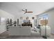 Bright living room features neutral décor, a ceiling fan, and a sliding glass door to the backyard at 31221 N 130Th Ln, Peoria, AZ 85383