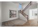 Spacious living room showcases tile flooring, a staircase, and large windows at 31221 N 130Th Ln, Peoria, AZ 85383