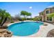 Inviting backyard pool surrounded by lush landscaping and scenic desert views at 31221 N 130Th Ln, Peoria, AZ 85383