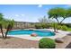 Inviting pool featuring rock features, lush green landscaping and beautiful desert views at 31221 N 130Th Ln, Peoria, AZ 85383