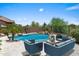 Beautiful pool area with outdoor seating, perfect for relaxing and entertaining guests at 31221 N 130Th Ln, Peoria, AZ 85383