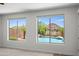 Relaxing view to the backyard pool area through two large windows from the light-filled room at 31221 N 130Th Ln, Peoria, AZ 85383