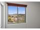 A window view from the home overlooks desert landscaping and distant homes at 31221 N 130Th Ln, Peoria, AZ 85383