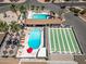 Aerial view of pools and shuffleboard courts surrounded by palm trees and outdoor seating areas at 4065 E University -- # 433, Mesa, AZ 85202