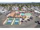 A wide aerial view reveals the community's layout with a pool, tennis courts, and ample parking surrounding a central clubhouse at 4065 E University -- # 433, Mesa, AZ 85202